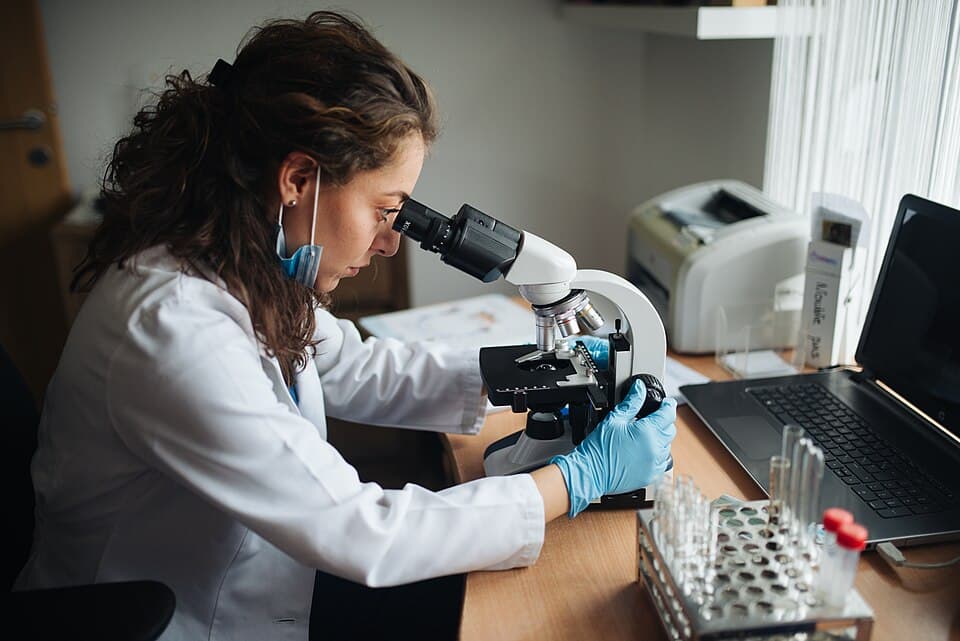 Laboratory technician working with data and equipment